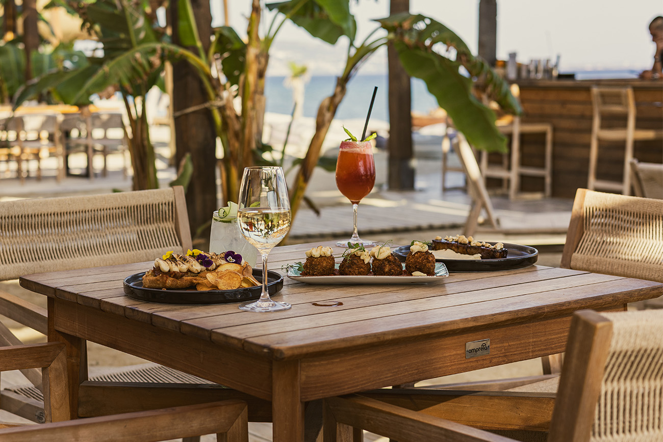 Fire pit on the sand among the loungers